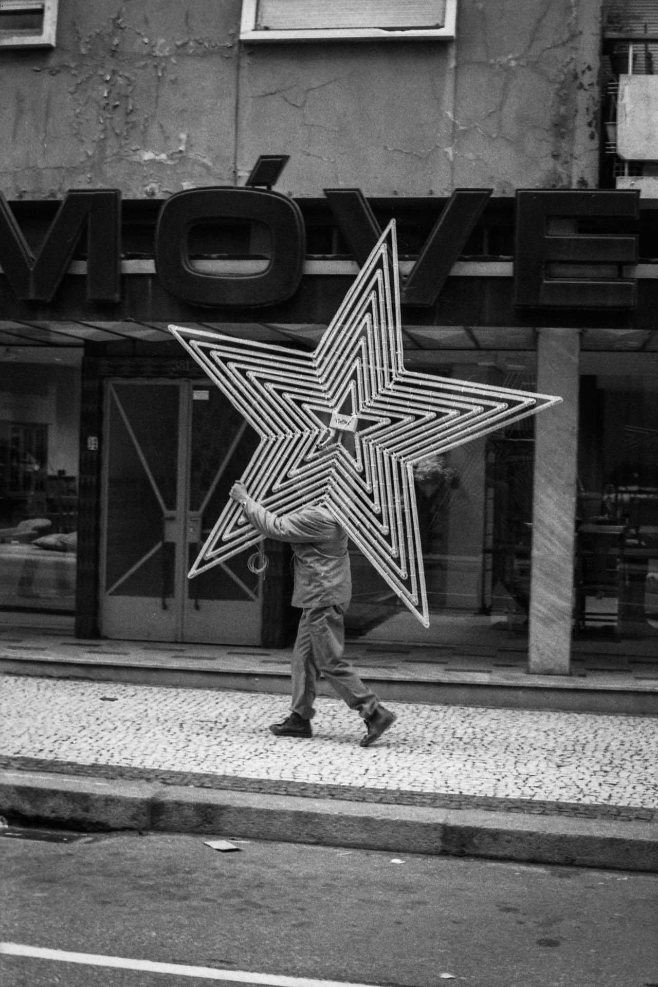 A man carrying a star in the street.