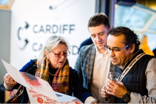 Guests at AMDANI reading the Creative Cardiff 202 calendar