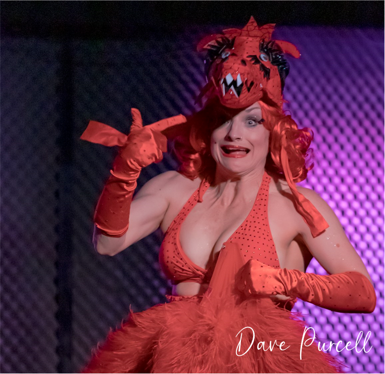 a burlesque dancer dressed as a red dragon