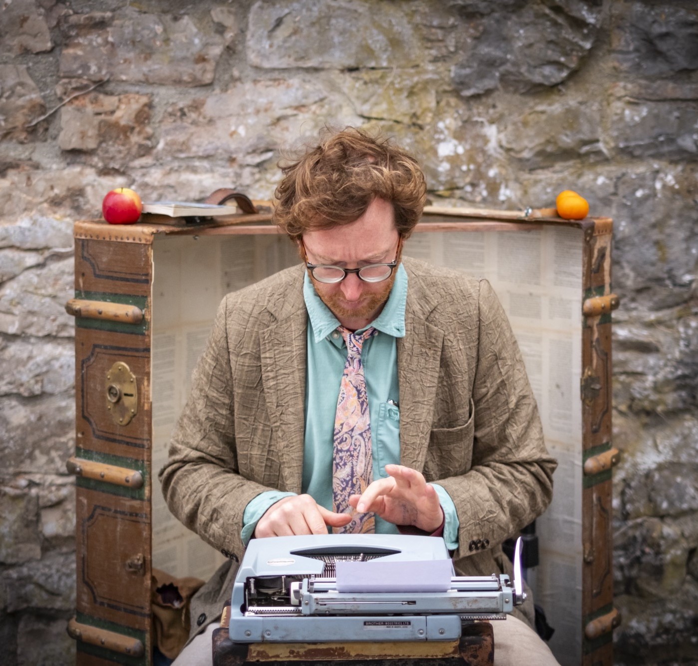 Adam E. Holton improvising stories on a typewriter.