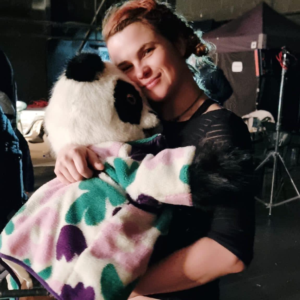 Me on set of a VAX commercial with a panda puppet I made with my colleague Hugh Purves