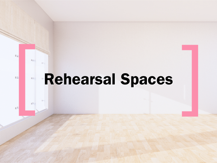 A faded background of a rehearsal room, over which text reads 'Rehearsal Spaces' in between the Creative Cardiff Brackets in Pink 