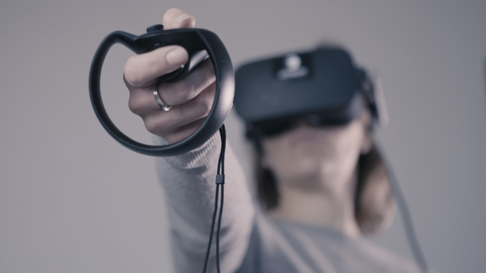 Person with VR headset on and pointing the pointer in front