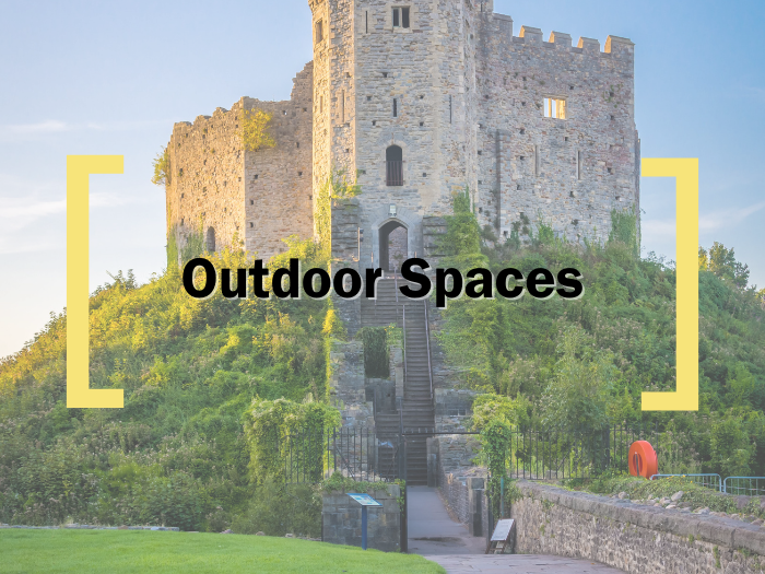 A faded background of Cardiff Castle, over which text reads 'Outdoor Spaces' in between the Creative Cardiff Brackets in Yellow 