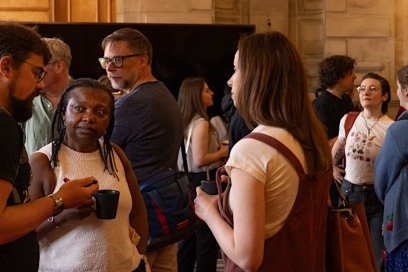 group of people talking holding mugs